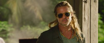 Movie still from “The Lost City” (2022), directed by Aaron Nee – A person wearing sunglasses with long hair; Close Up shot, Low angle
