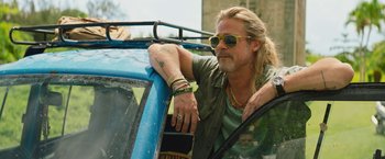 Movie still from “The Lost City” (2022), directed by Aaron Nee – A man leaning out of the window of a blue van; Close Up shot, Low angle