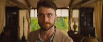 Movie still from “The Lost City” (2022), directed by Aaron Nee – A person with a beard; Close Up shot, Over the shoulder angle