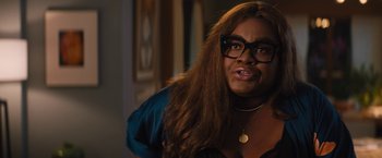 Movie still from “The Lost City” (2022), directed by Aaron Nee – A woman wearing glasses and a blue shirt; Close Up shot, Over the shoulder angle