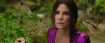 Movie still from “The Lost City” (2022), directed by Aaron Nee – A person wearing a purple shirt; Close Up shot, High angle