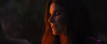 Movie still from “The Lost City” (2022), directed by Aaron Nee – A person with long red hair; Close Up shot, Low angle