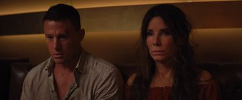 Movie still from “The Lost City” (2022), directed by Aaron Nee – A man and a woman sitting next to each other; Close Up shot, Over the shoulder angle