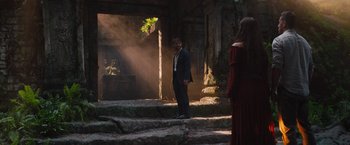 Movie still from “The Lost City” (2022), directed by Aaron Nee – A man and a woman standing on some steps; Wide shot, Over the shoulder angle