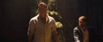 Movie still from “The Lost City” (2022), directed by Aaron Nee – A man standing in front of an egyptian statue; Medium shot, Over the shoulder angle