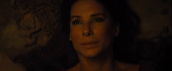 Movie still from “The Lost City” (2022), directed by Aaron Nee – A woman's face in the dark; Close Up shot, Overhead angle