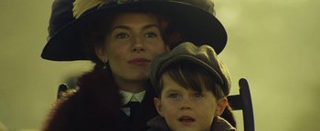 Movie still from “The Lost City of Z” (2016), directed by James Gray – A woman and a boy wearing a hat; Close Up shot, Low angle