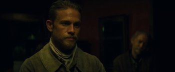 Movie still from “The Lost City of Z” (2016), directed by James Gray – A person wearing a suit and tie; Close Up shot, Over the shoulder angle