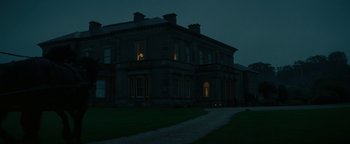 Movie still from “The Lost City of Z” (2016), directed by James Gray – A large building with a clock on the outside of it's windows; Extreme Wide shot, Low angle