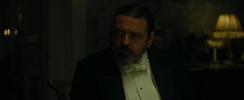 Movie still from “The Lost City of Z” (2016), directed by James Gray – A man in a suit and a bow tie; Close Up shot, Low angle