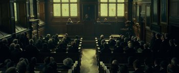 Movie still from “The Lost City of Z” (2016), directed by James Gray – A group of people sitting in a room with chairs; Extreme Wide shot, High angle