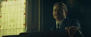 Movie still from “The Lost City of Z” (2016), directed by James Gray – A man in a suit and tie looking into a mirror; Close Up shot, Low angle