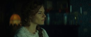 Movie still from “The Lost City of Z” (2016), directed by James Gray – A woman in a white shirt is looking to the side; Close Up shot, Over the shoulder angle