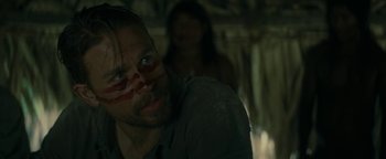 Movie still from “The Lost City of Z” (2016), directed by James Gray – A person with a face paint; Close Up shot, Over the shoulder angle