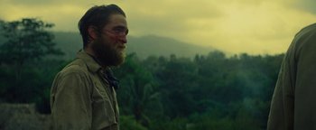Movie still from “The Lost City of Z” (2016), directed by James Gray – A man with a beard is looking out at the mountains; Medium shot, Over the shoulder angle