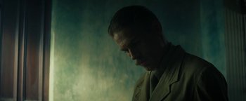 Movie still from “The Lost City of Z” (2016), directed by James Gray – A man in a suit and tie looking to his left; Close Up shot, Low angle