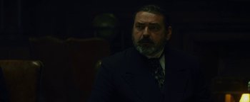 Movie still from “The Lost City of Z” (2016), directed by James Gray – A man in a suit and tie looking at the camera; Close Up shot, Low angle