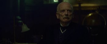 Movie still from “The Lost City of Z” (2016), directed by James Gray – An old man with a beard is looking at the camera; Close Up shot, Low angle