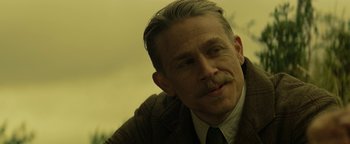 Movie still from “The Lost City of Z” (2016), directed by James Gray – A person wearing a suit and tie; Close Up shot, Over the shoulder angle