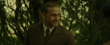 Movie still from “The Lost City of Z” (2016), directed by James Gray – A person wearing a suit and tie; Close Up shot, Low angle