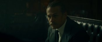 Movie still from “The Lost City of Z” (2016), directed by James Gray – A man in a suit and tie sitting in front of a window; Close Up shot, Low angle