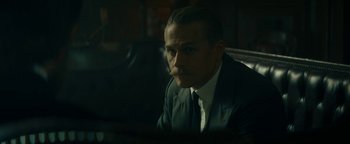 Movie still from “The Lost City of Z” (2016), directed by James Gray – A man in a suit and tie sitting in a chair; Close Up shot, Low angle