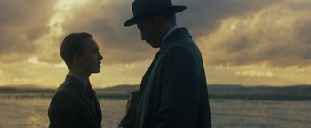 Movie still from “The Lost City of Z” (2016), directed by James Gray – A man and a woman standing next to each other in a field; Medium shot, Low angle