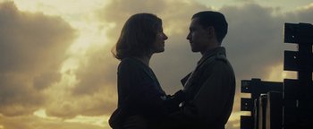 Movie still from “The Lost City of Z” (2016), directed by James Gray – A man and a woman standing next to each other in front of a cloudy sky; Close Up shot, Low angle