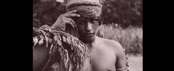 Movie still from “The Lost City of Z” (2016), directed by James Gray – A young man wearing a native american headdress; Close Up shot, Low angle