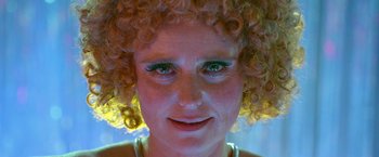 Movie still from “The Lure” (2015), directed by Agnieszka Smoczynska – A person with curly hair; Extreme Close Up shot, Over the shoulder angle