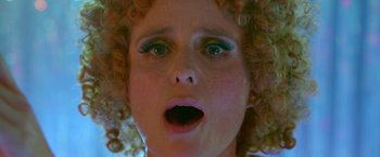 Movie still from “The Lure” (2015), directed by Agnieszka Smoczynska – A person with curly hair looking surprised; Extreme Close Up shot, Overhead angle