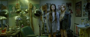 Movie still from “The Lure” (2015), directed by Agnieszka Smoczynska – Two women standing in front of a hair dryer; Medium shot, High angle