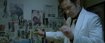 Movie still from “The Lure” (2015), directed by Agnieszka Smoczynska – A man holding a green toothbrush in his hand; Medium shot, Over the shoulder angle