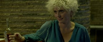 Movie still from “The Lure” (2015), directed by Agnieszka Smoczynska – A woman with blonde curly hair wearing a blue shirt; Close Up shot, Low angle