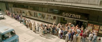 Movie still from “The Lure” (2015), directed by Agnieszka Smoczynska – A group of people standing in front of a building; Extreme Wide shot, High angle