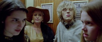 Movie still from “The Lure” (2015), directed by Agnieszka Smoczynska – A woman and a man in a hat and headphones; Close Up shot, Low angle
