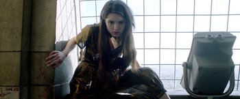 Movie still from “The Lure” (2015), directed by Agnieszka Smoczynska – A woman sitting on the ground in front of a window; Medium shot, Low angle