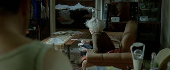 Movie still from “The Lure” (2015), directed by Agnieszka Smoczynska – A woman sitting in a chair playing a video game; Medium shot, Over the shoulder angle