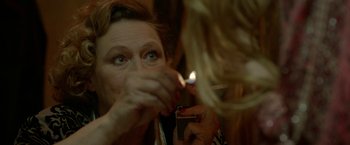 Movie still from “The Lure” (2015), directed by Agnieszka Smoczynska – A woman lighting a cigarette on a cell phone; Close Up shot, Over the shoulder angle