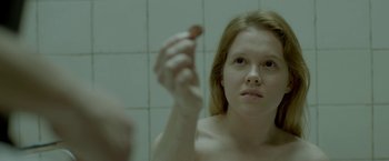 Movie still from “The Lure” (2015), directed by Agnieszka Smoczynska – A young woman looking into a mirror in a bathroom; Close Up shot, Over the shoulder angle