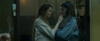 Movie still from “The Lure” (2015), directed by Agnieszka Smoczynska – Two women standing next to each other in a room; Close Up shot, Over the shoulder angle