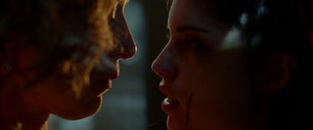 Movie still from “The Lure” (2015), directed by Agnieszka Smoczynska – Two women face each other with blood on their face; Extreme Close Up shot, Low angle