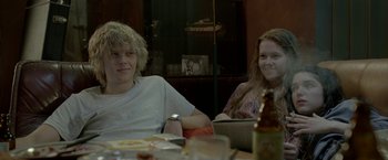 Movie still from “The Lure” (2015), directed by Agnieszka Smoczynska – A man and a woman sitting at a dinner table; Medium shot, Over the shoulder angle