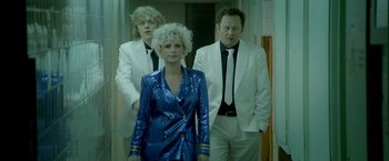 Movie still from “The Lure” (2015), directed by Agnieszka Smoczynska – A group of people standing next to each other in front of a mirror; Medium shot, Low angle