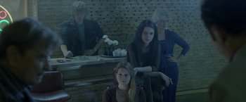 Movie still from “The Lure” (2015), directed by Agnieszka Smoczynska – A group of people sitting in a room; Medium shot, Low angle