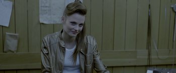 Movie still from “The Lure” (2015), directed by Agnieszka Smoczynska – A young woman with long brown hair wearing a leather jacket; Close Up shot, Over the shoulder angle