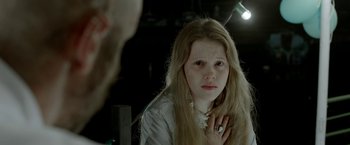 Movie still from “The Lure” (2015), directed by Agnieszka Smoczynska – A woman looking into a bathroom mirror with her hand on her chin; Close Up shot, Over the shoulder angle