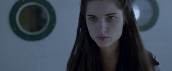 Movie still from “The Lure” (2015), directed by Agnieszka Smoczynska – A person with long black hair; Close Up shot, Over the shoulder angle