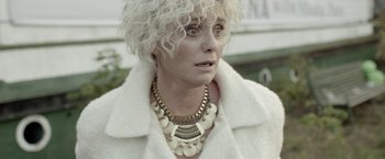 Movie still from “The Lure” (2015), directed by Agnieszka Smoczynska – A person wearing a necklace; Close Up shot, Over the shoulder angle