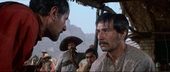 Movie still from “The Magnificent Seven” (1960), directed by John Sturges – A group of men standing next to each other on top of a hill; Close Up shot, Over the shoulder angle